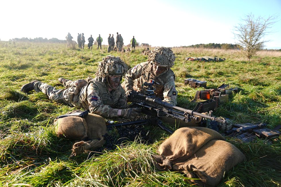 Members of the Welsh Guards prepare a general-purpose machine gun (GPMG) on Salisbury Plain, Wiltshire