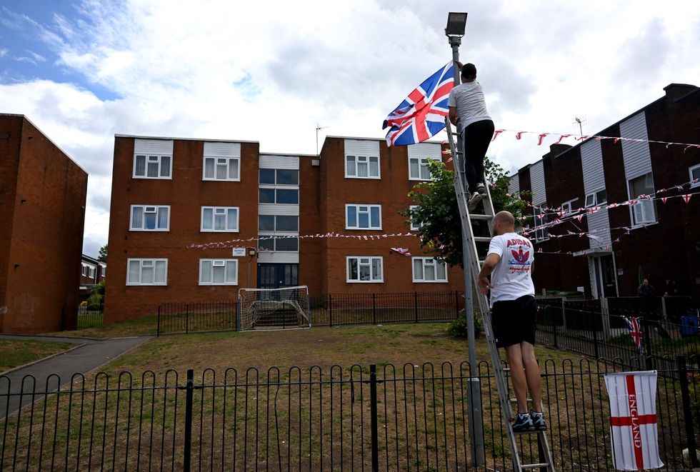 Men hanging flags