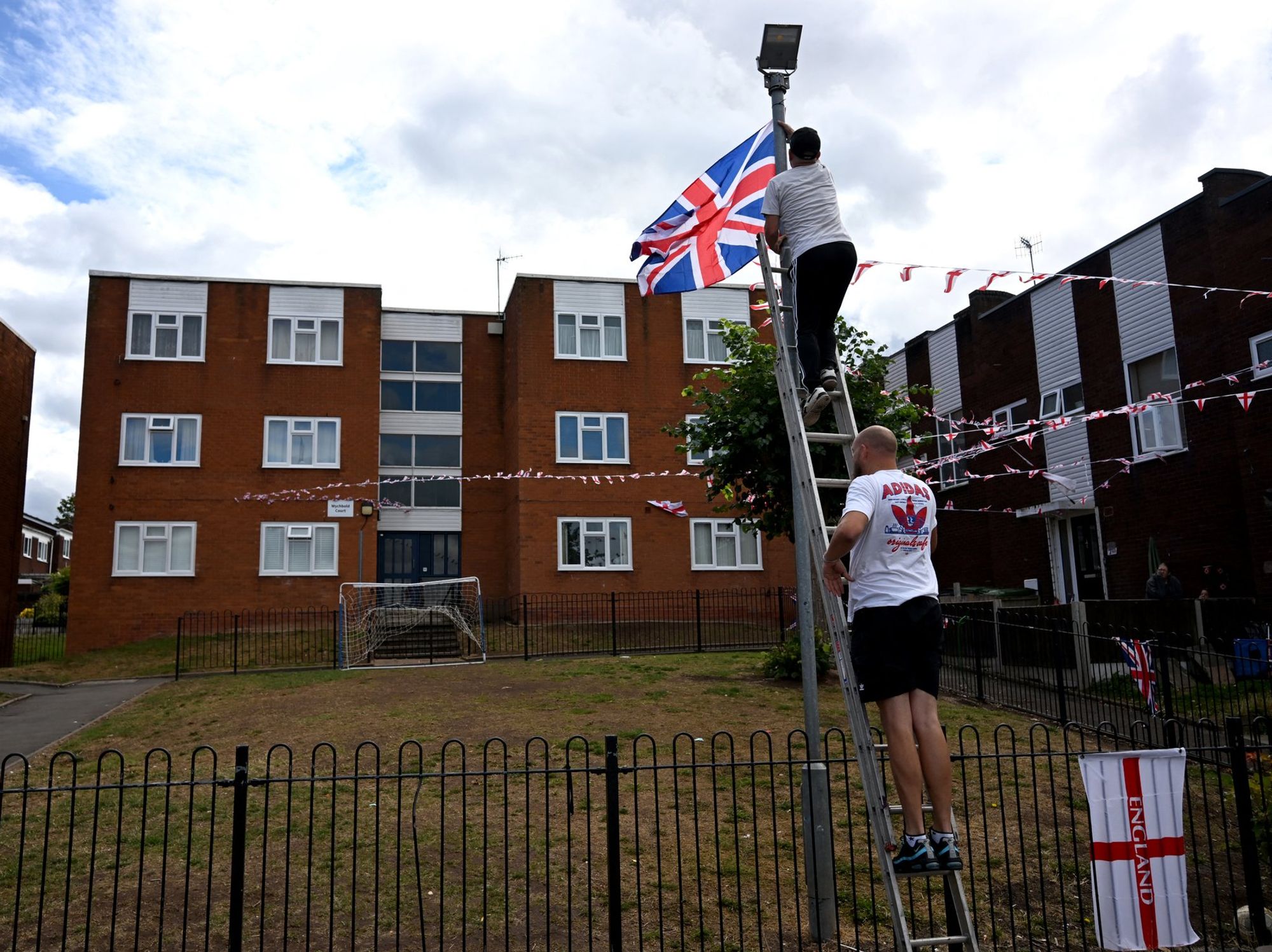 Men hanging Union Jack and English flags