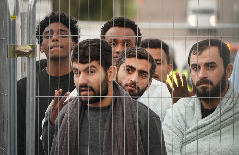 Men thought to be a migrants at the Manston immigration short-term holding facility located at the former Defence Fire Training and Development Centre in Thanet, Kent. Picture date: Tuesday November 8, 2022.