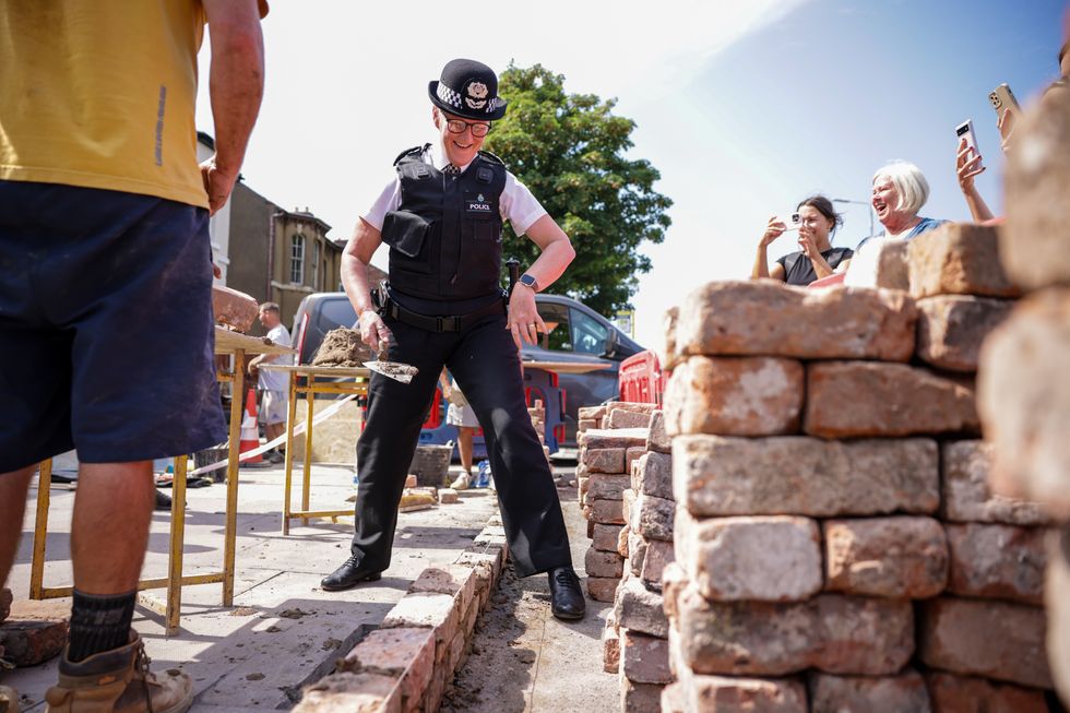Merseyside Police Chief Constable Serena Kennedy helps rebuild a wall outside the Southport Islamic Centre Mosque