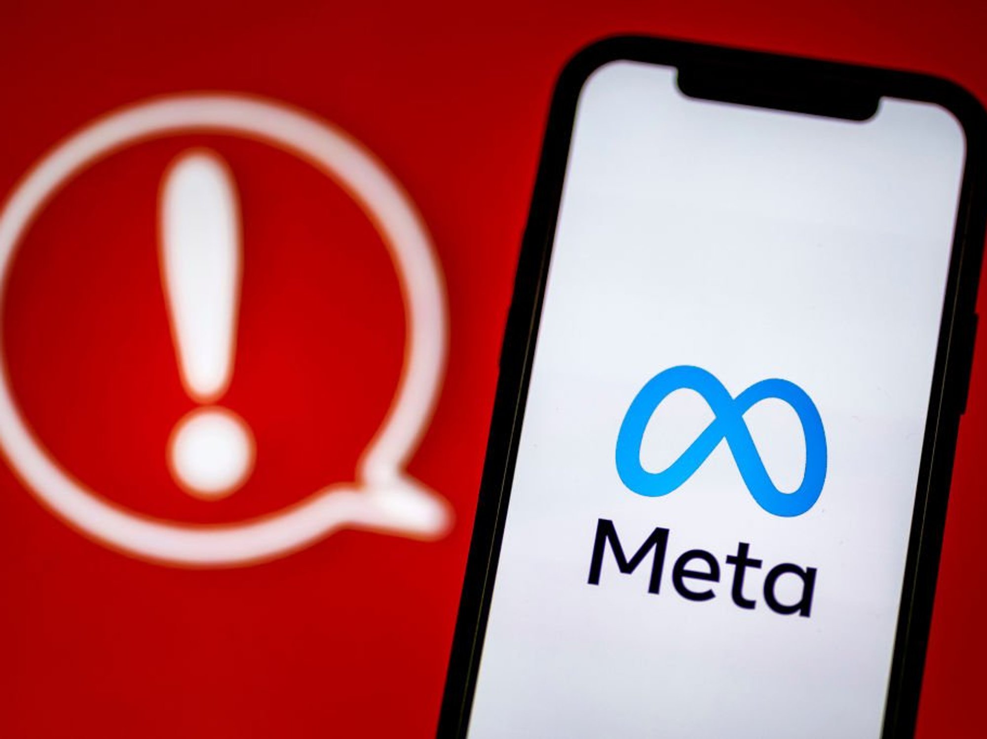 Meta logo with red exclamation point
