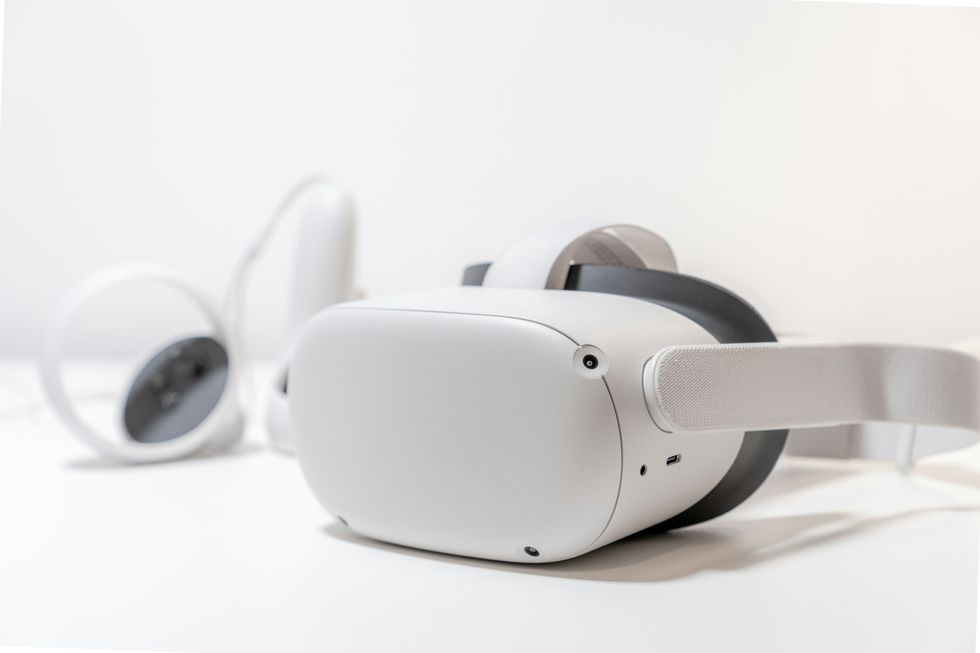 meta quest 2 headset pictured with its two controllers by its side