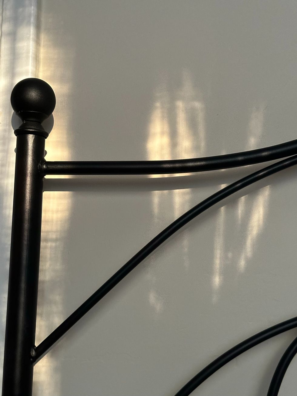 Metal bed frame against wall