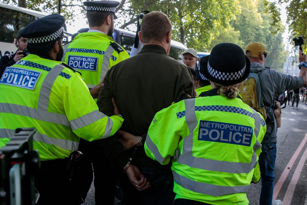 Metropolitan Police officers arrest a pro-Israel activist