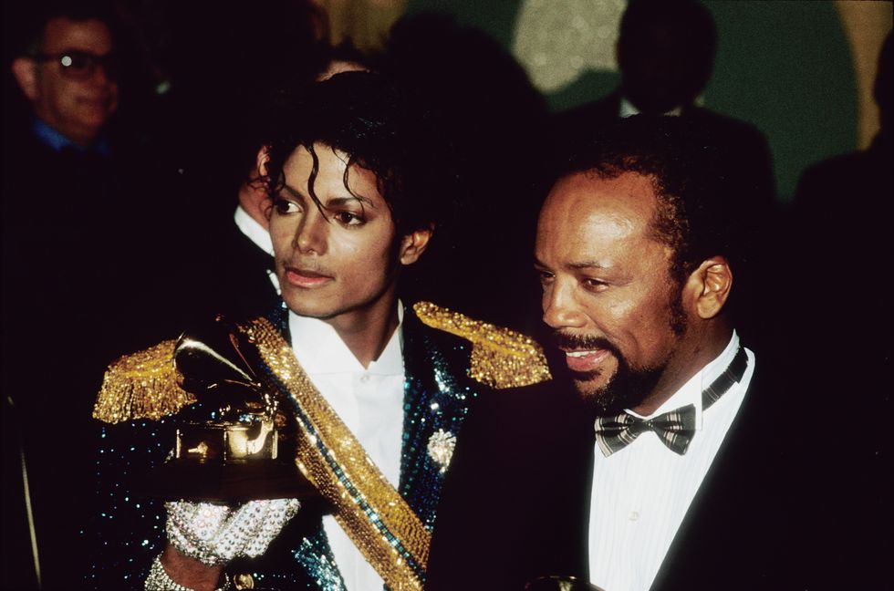 Michael Jackson and his producer Quincy Jones pose with their Grammys