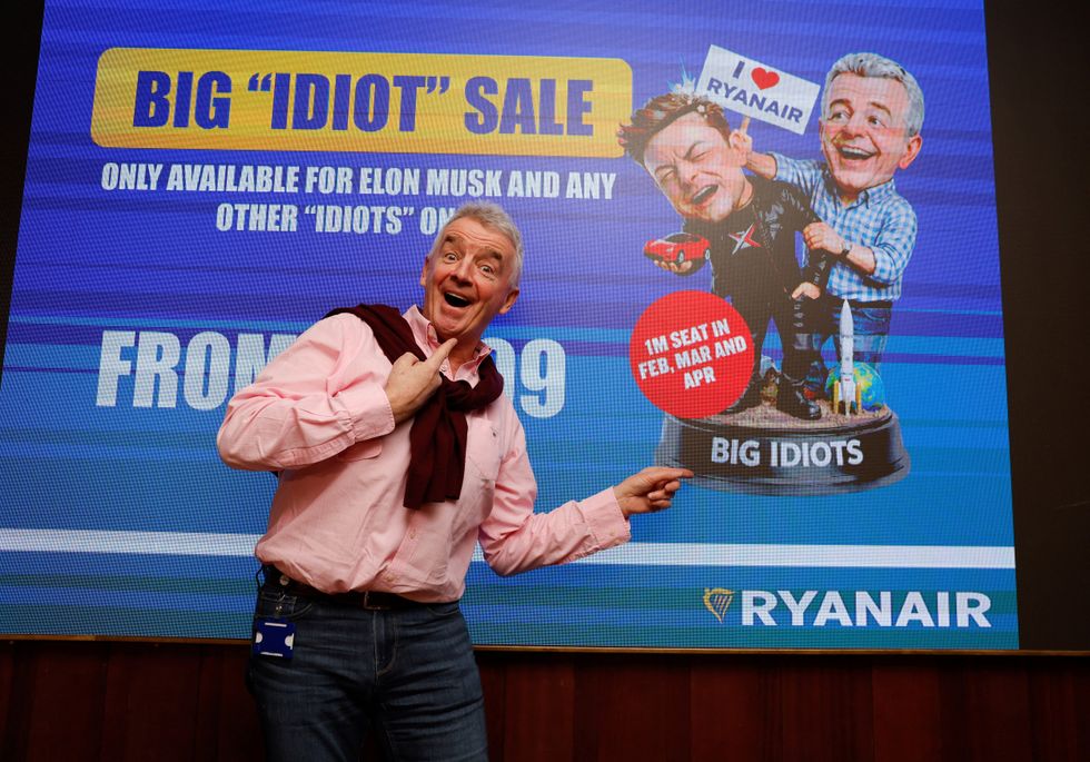 Michael O\u2019Leary standing in front of 'Big idiot sale' sign