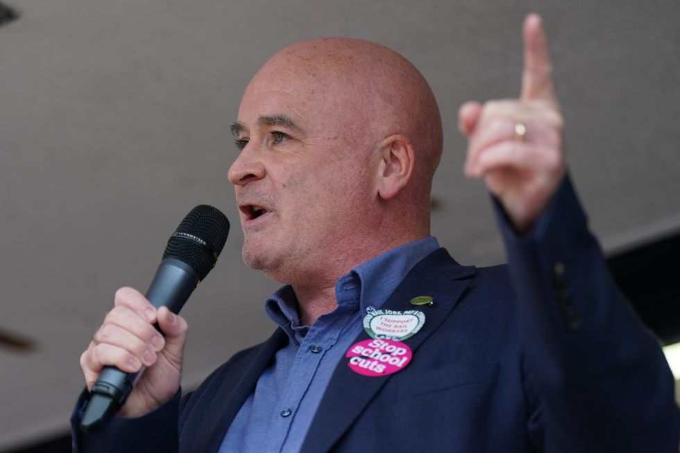 Mick Lynch, general secretary of the Rail, Maritime and Transport union (RMT) speaks to the crowd at a rally in Victoria Square, outside the Conservative Party annual conference at the International Convention Centre in Birmingham. Picture date: Sunday October 2, 2022.