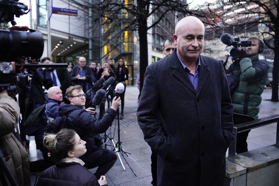 Mick Lynch surrounded by reporters