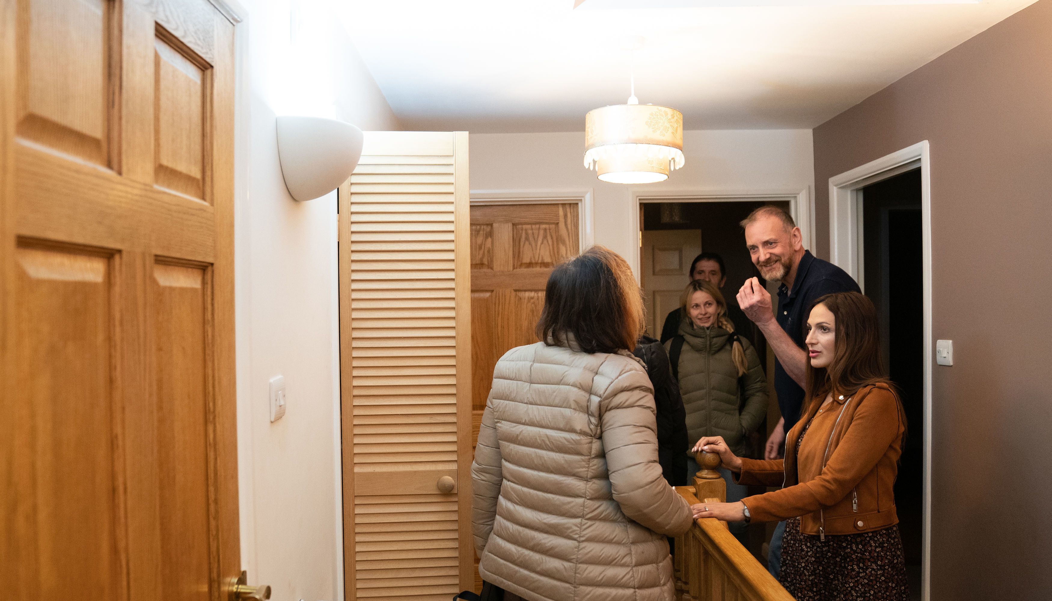Mick Swinhoe and Rend Platings show Iryna Starkova and her family around their new home in Caldecote near Cambridge. The family of ten who range in age from Alikhan, aged 10, to 90-year-old grandmother Ludmila, fled Kharkiv in the Ukraine following the Russian invasion, beginning their journeys on March 1. They have been helped by Rend Platings to find a new home in the UK for them and their two dogs Mikki and Florie. Picture date: Tuesday March 22, 2022.