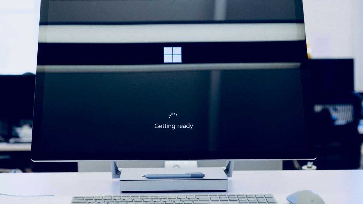 microsoft surface desktop PC pictured on a table with the Windows Getting Ready loading screen while an update is applied