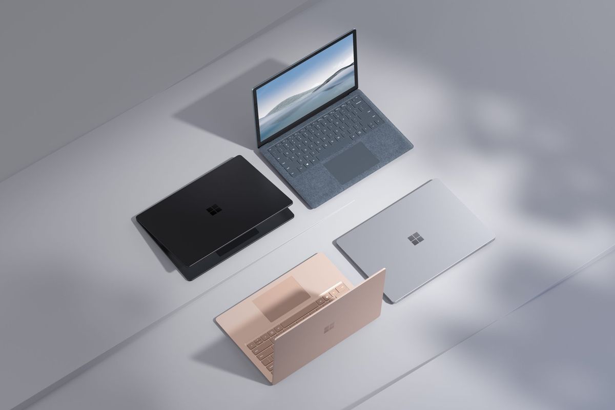 microsoft surface laptop models sat side-by-side on a grey desk 