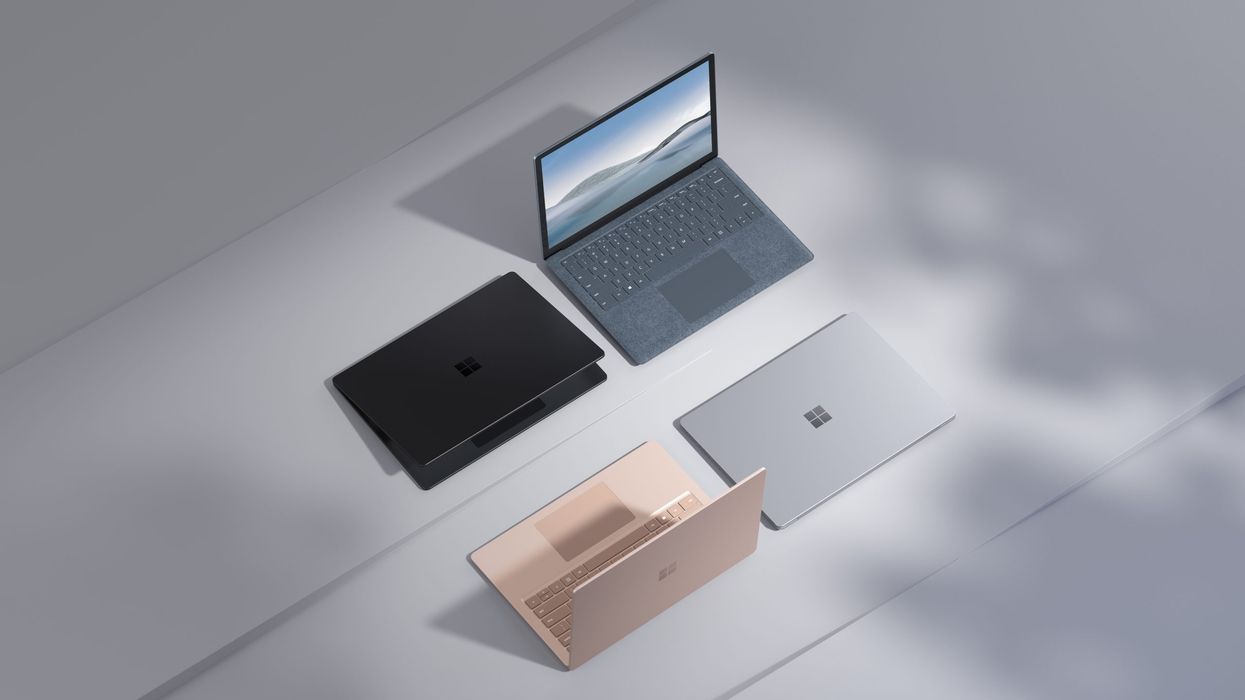 microsoft surface laptop models sat side-by-side on a grey desk