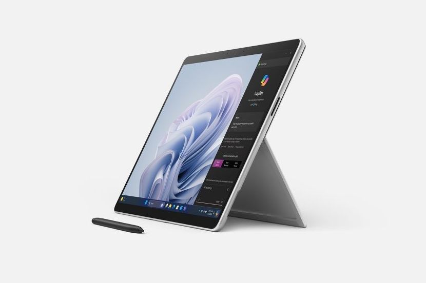 microsoft surface pro 10 for business pictured on blank background with surface pen stylus lying in front of the device