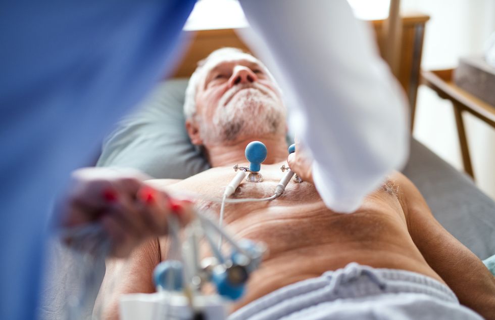 Middle-aged man getting examined in a hospital bed