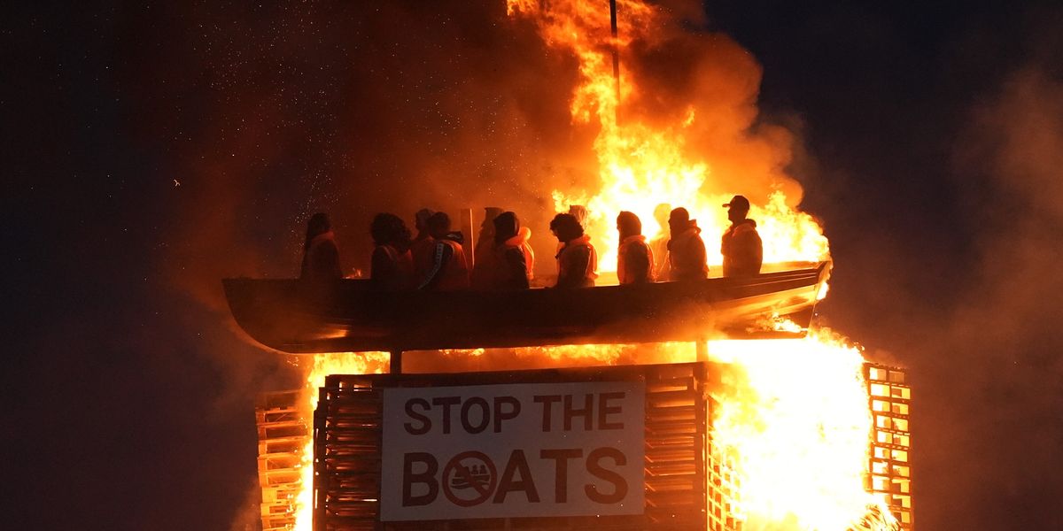 NextImg:Bonfire topped with migrant boat effigy set alight as police probe hate crime