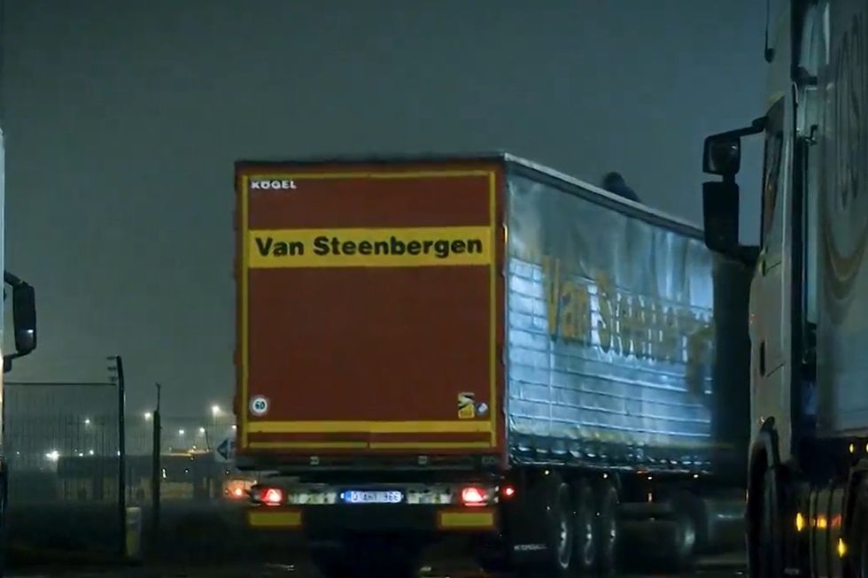 Migrant clings to roof of lorry