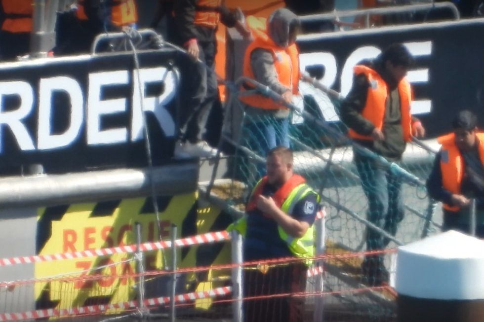 Migrant disembark Border Force vessel in Dover