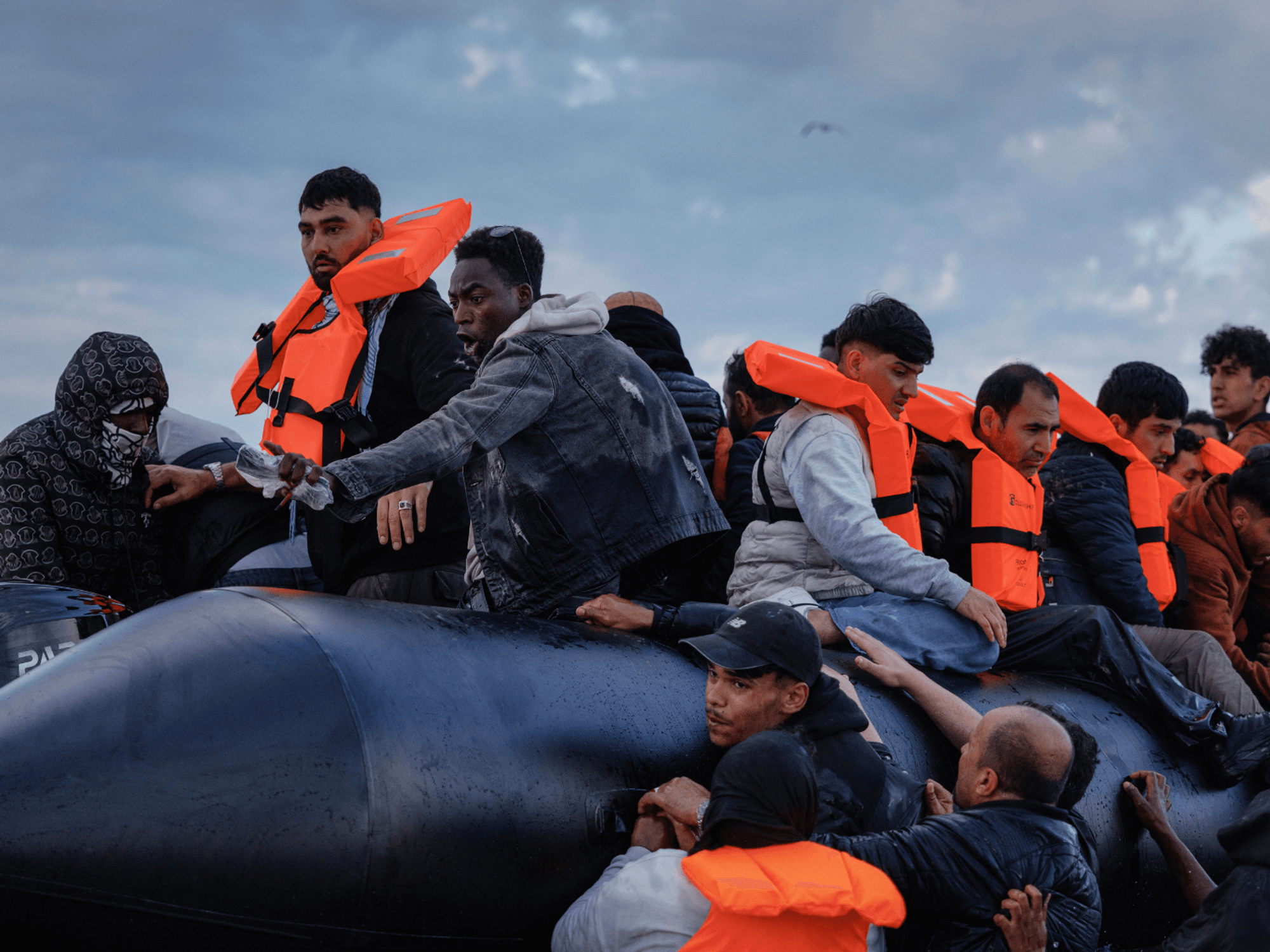Migrant families wade into the sea