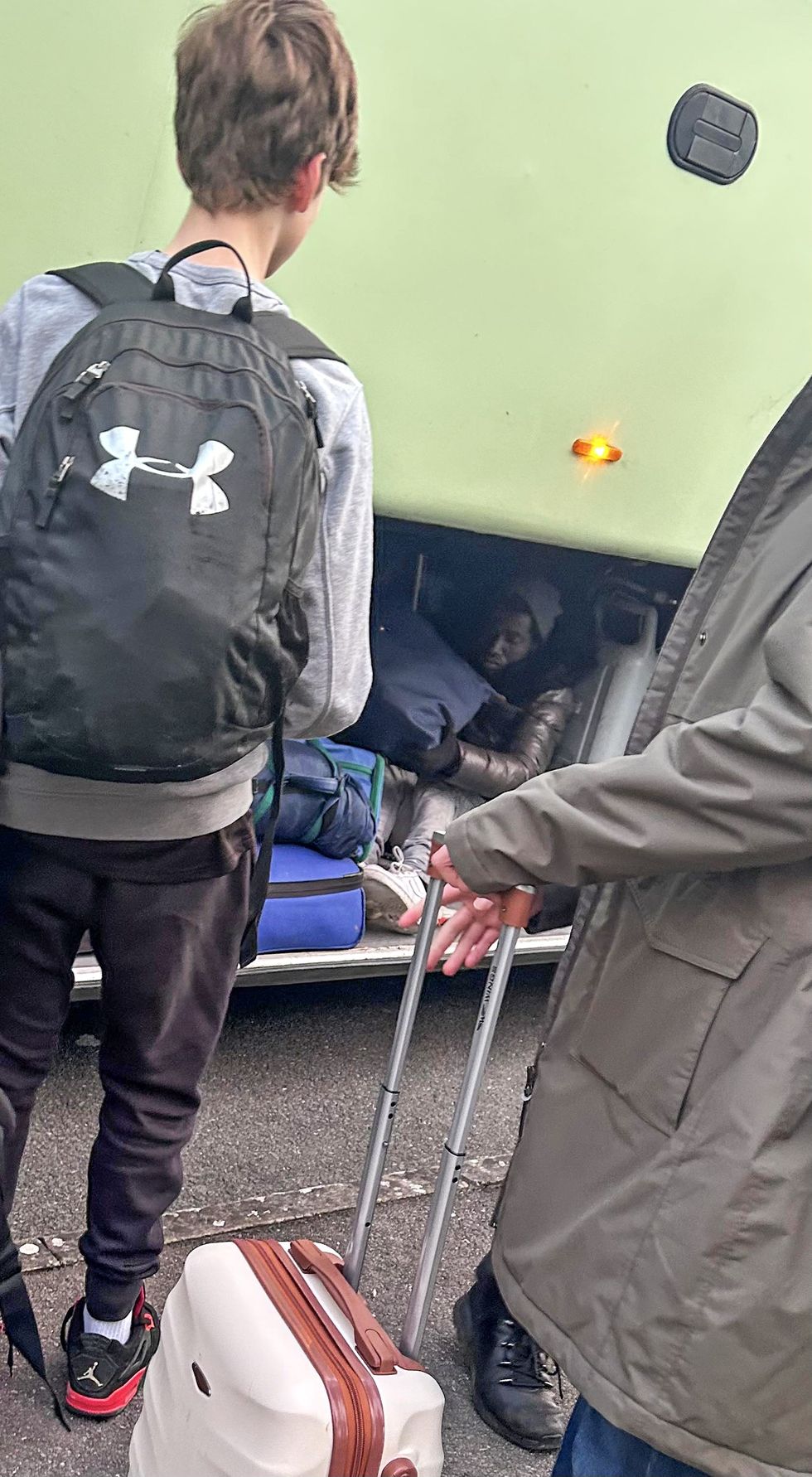 Migrant hiding in the bottom of the bus