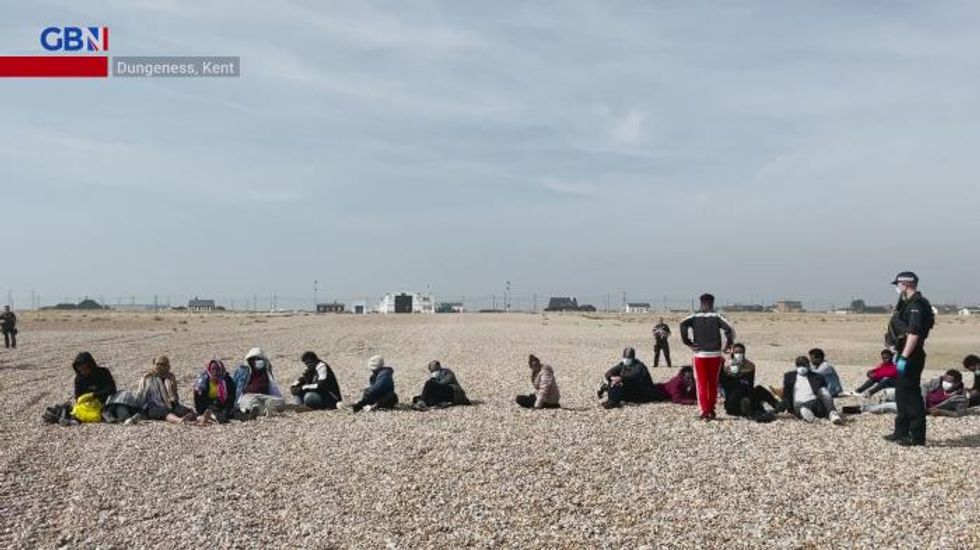A baby and several young children amongst large group of migrants brought ashore as Channel crossings continue