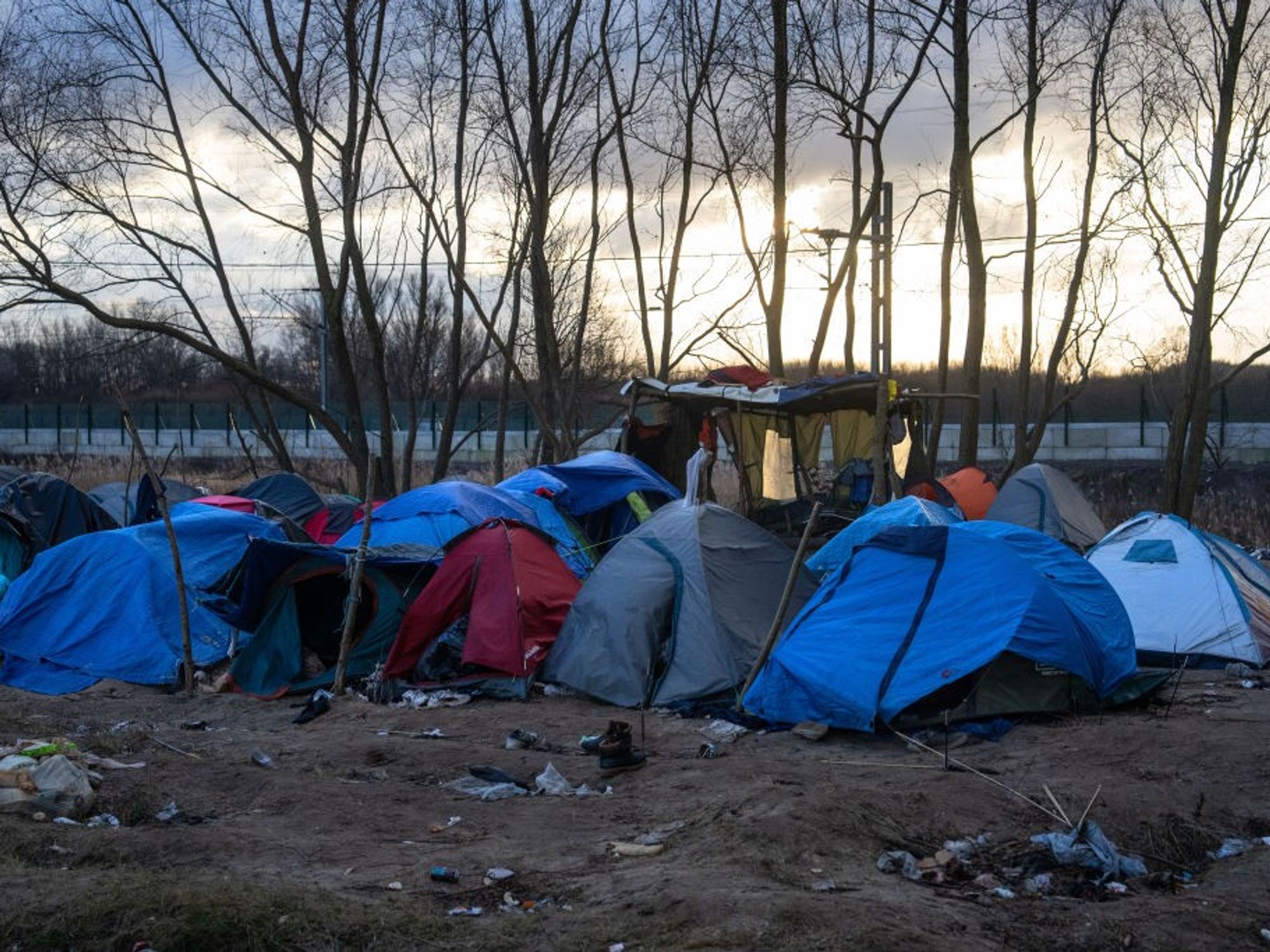 Migrant shot dead at French refugee camp as two-year-old child and five others left injured as vi...