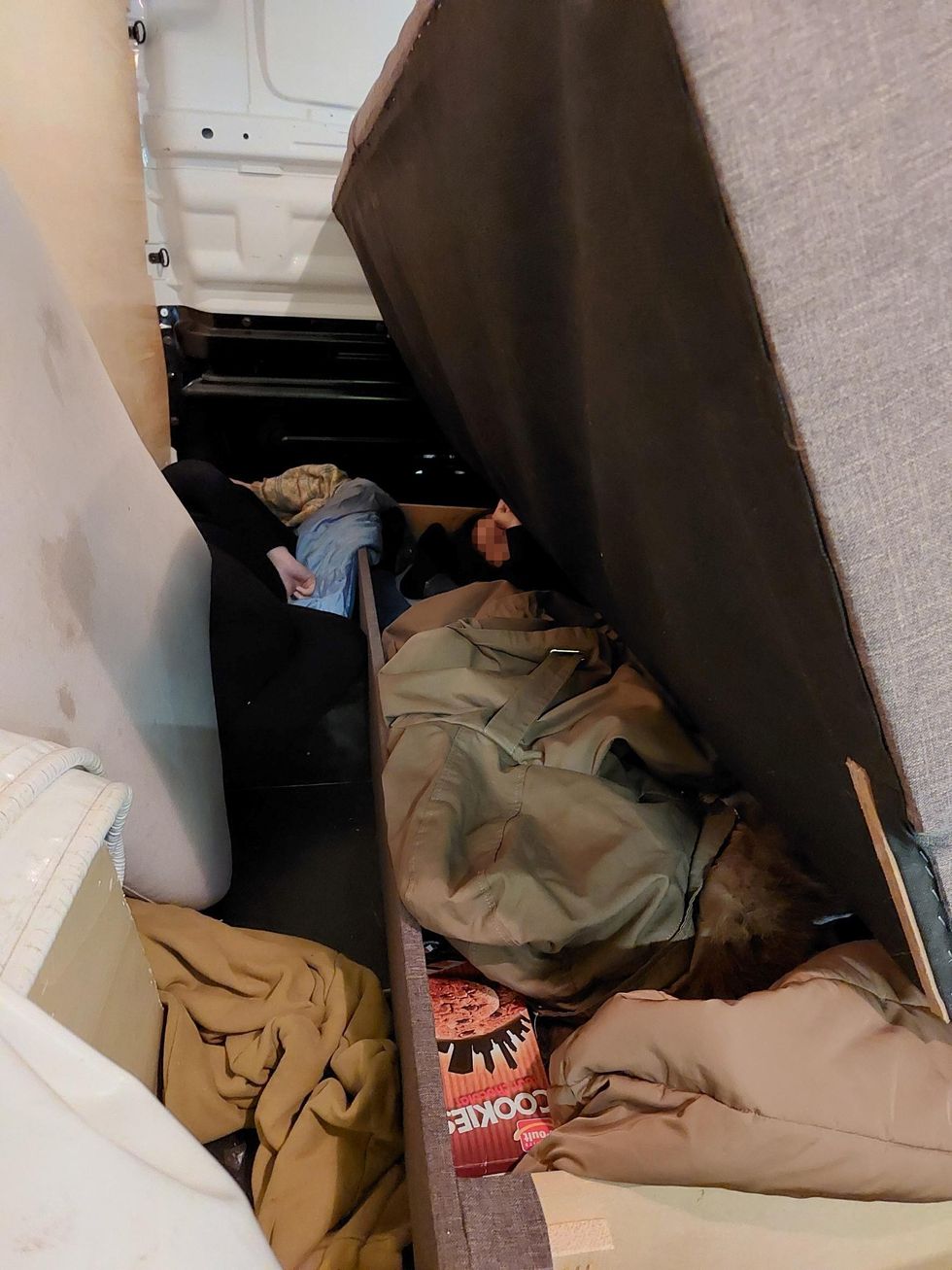 Migrant stuffed in sofa