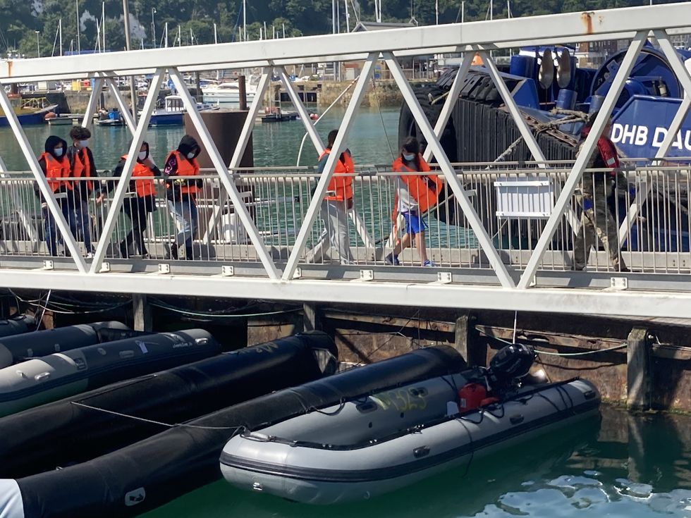Migrants are brought ashore in Dover, Kent, by Border Force officers. Picture date: Thursday June 16, 2022.