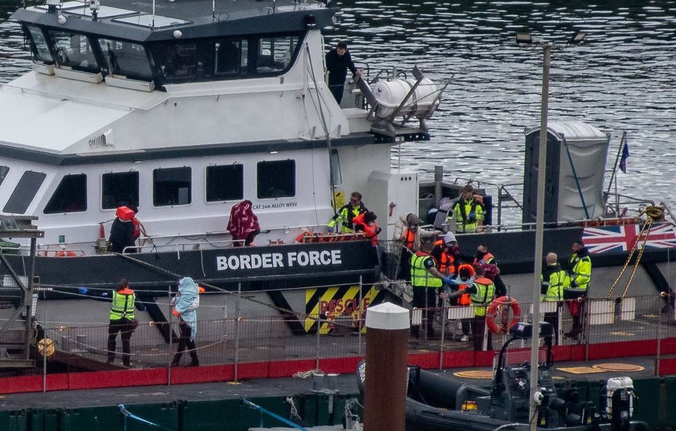 Migrants are brought into Dover Port by Border Force officials