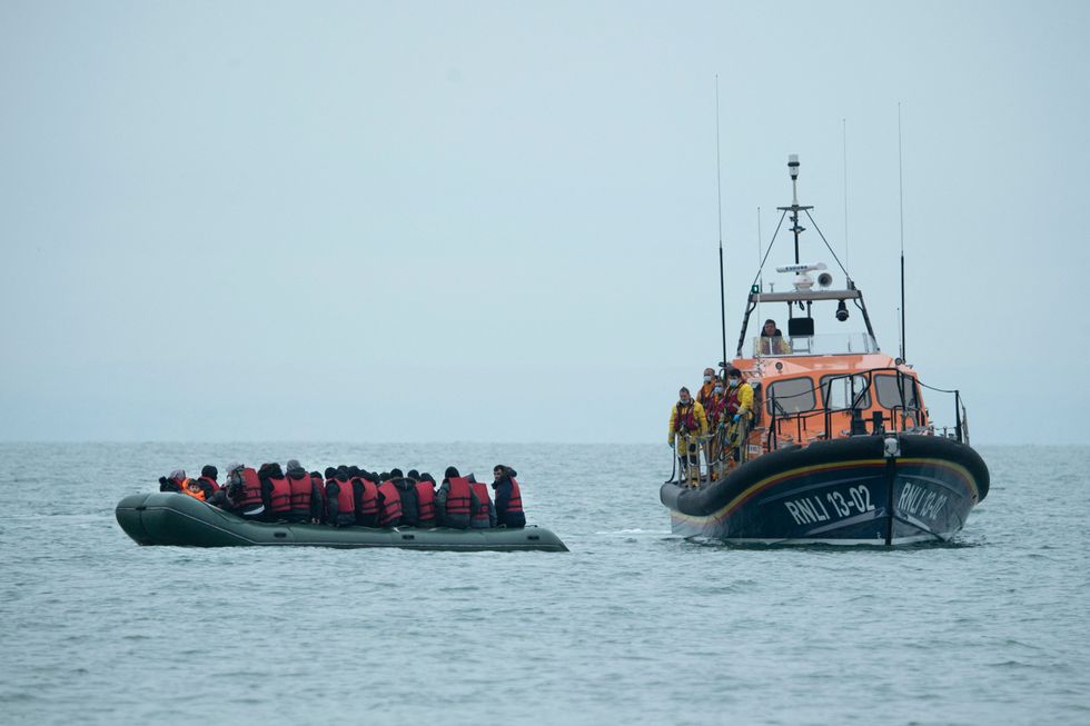 Migrants are helped by RNLI (Royal National Lifeboat Institution) lifeboat