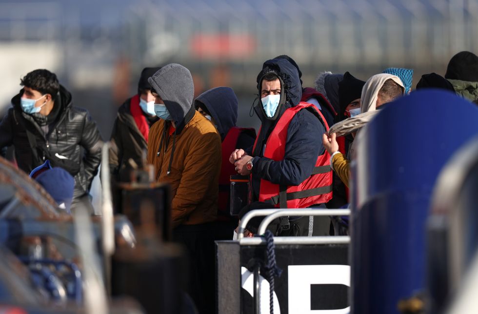 Migrants arrive onboard a Border Force boat at Dover harbour after crossing the channel, in Dover, Britain, November 18, 2021. REUTERS/Henry Nicholls