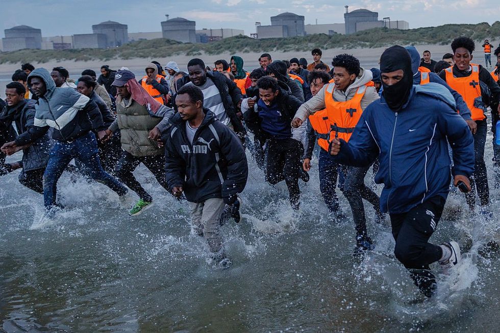 Migrants attempting to board a small boat in France