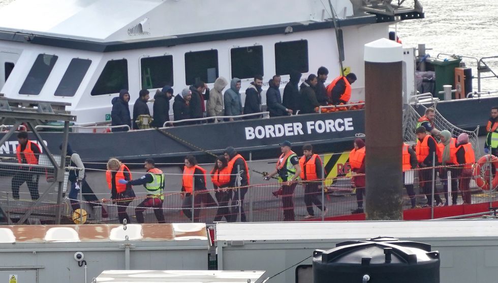 Migrants being led off ship