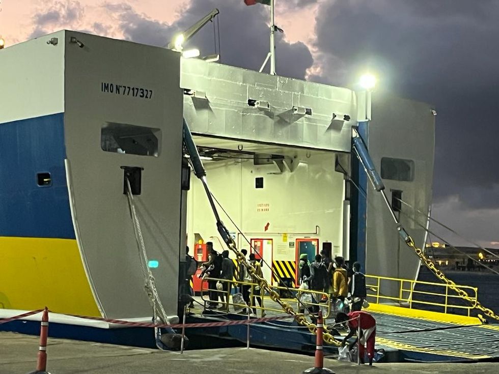 Migrants board boat in Lampedusa