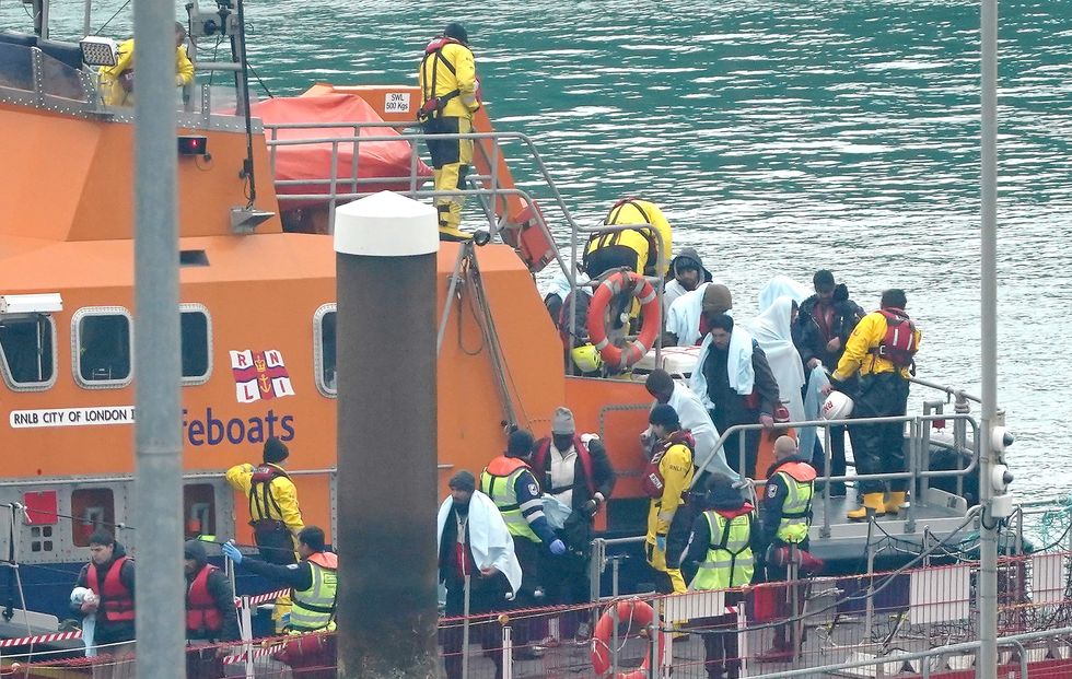 Migrants disembarking from an RNLI boat.