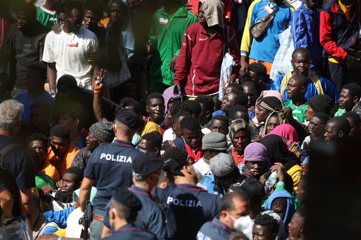 Migrants gather on the Italian island of Lampedusa