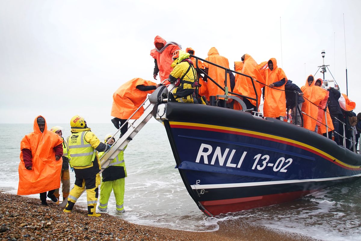 Migrants getting off a lifeboat 