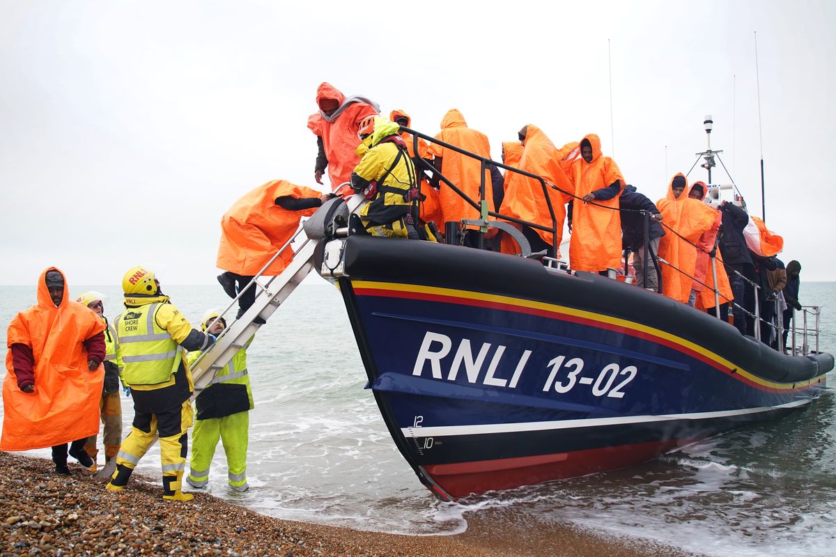 Migrants getting off a lifeboat 