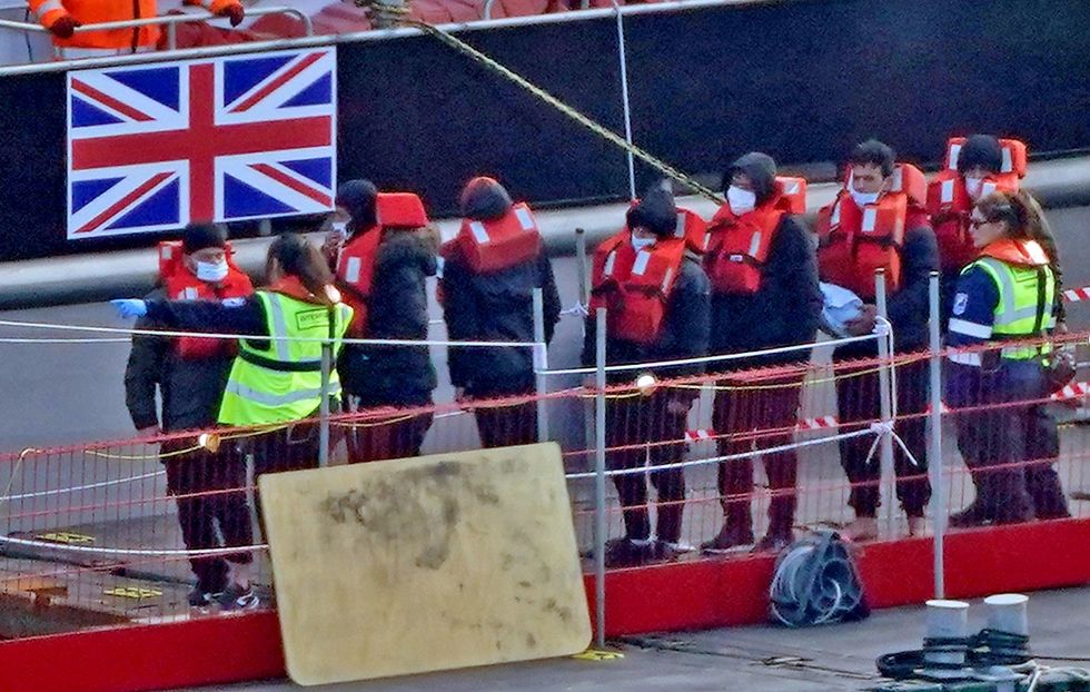 Migrants in lifejackets with border force control in Dover