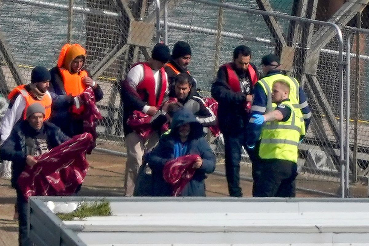 Migrants interacting with border patrol