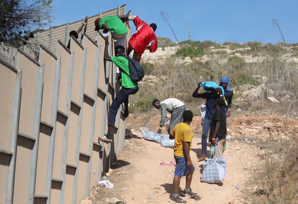 Migrants jumping the fence