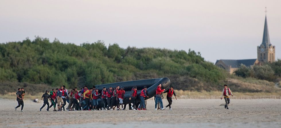 Migrants made their way down the beach at Gravelines in France