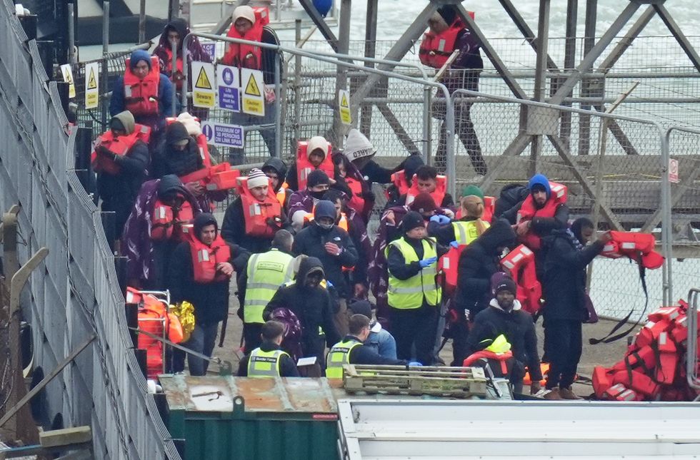 Migrants reach the UK after crossing the Channel