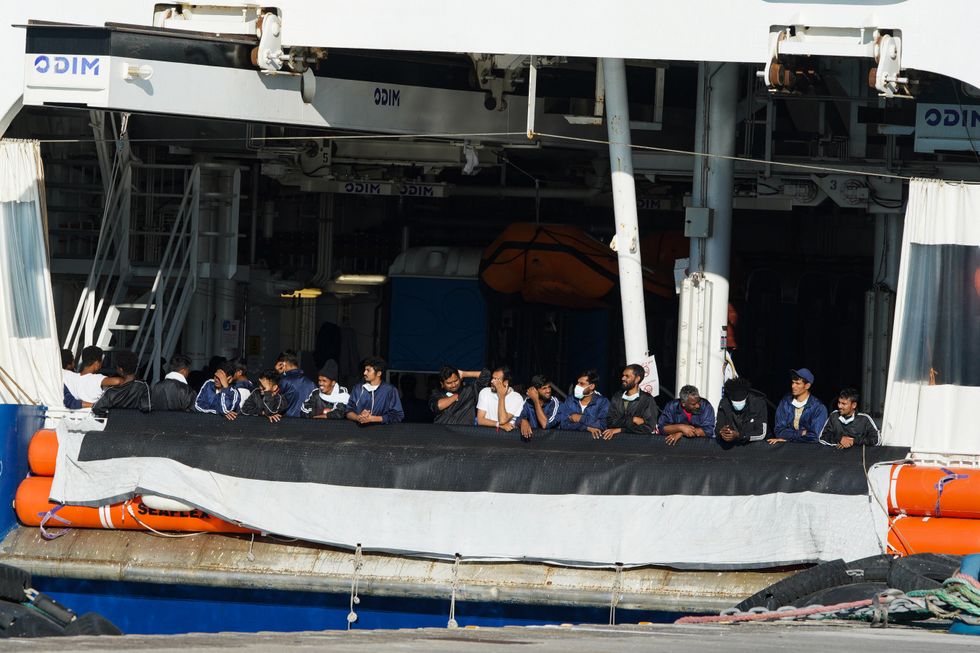 Migrants remaining on the NGO rescue ship Humanity stand onboard in the port of Catania after Italy allowed the disembarkation of children and sick people in Catania, Italy, November 7, 2022. REUTERS/Antonio Parrinello\u2028