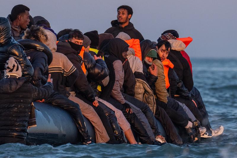 Migrants sat on a small boat