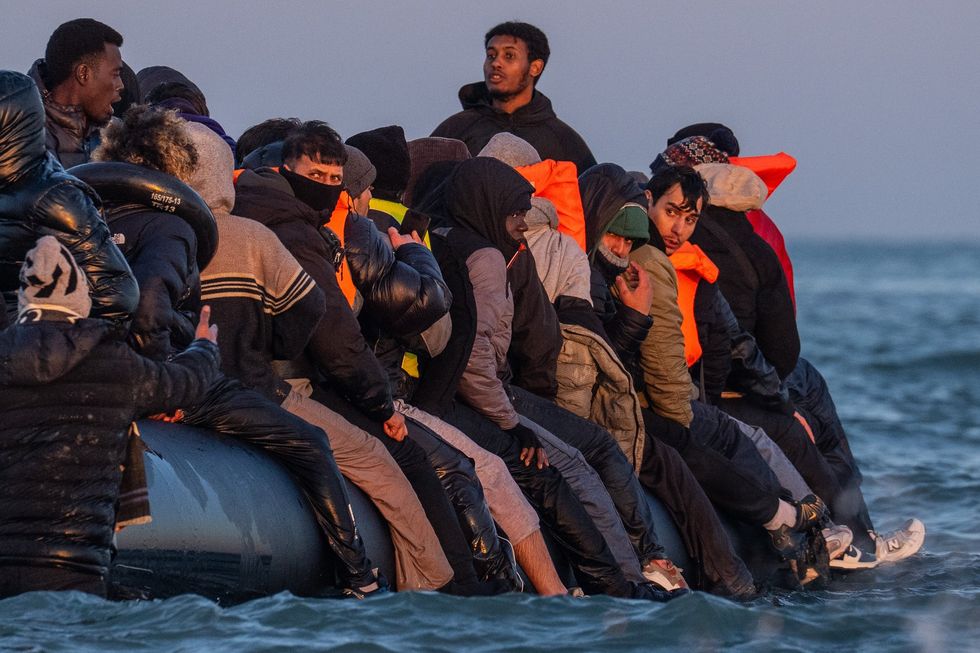 Migrants sat on a small boat