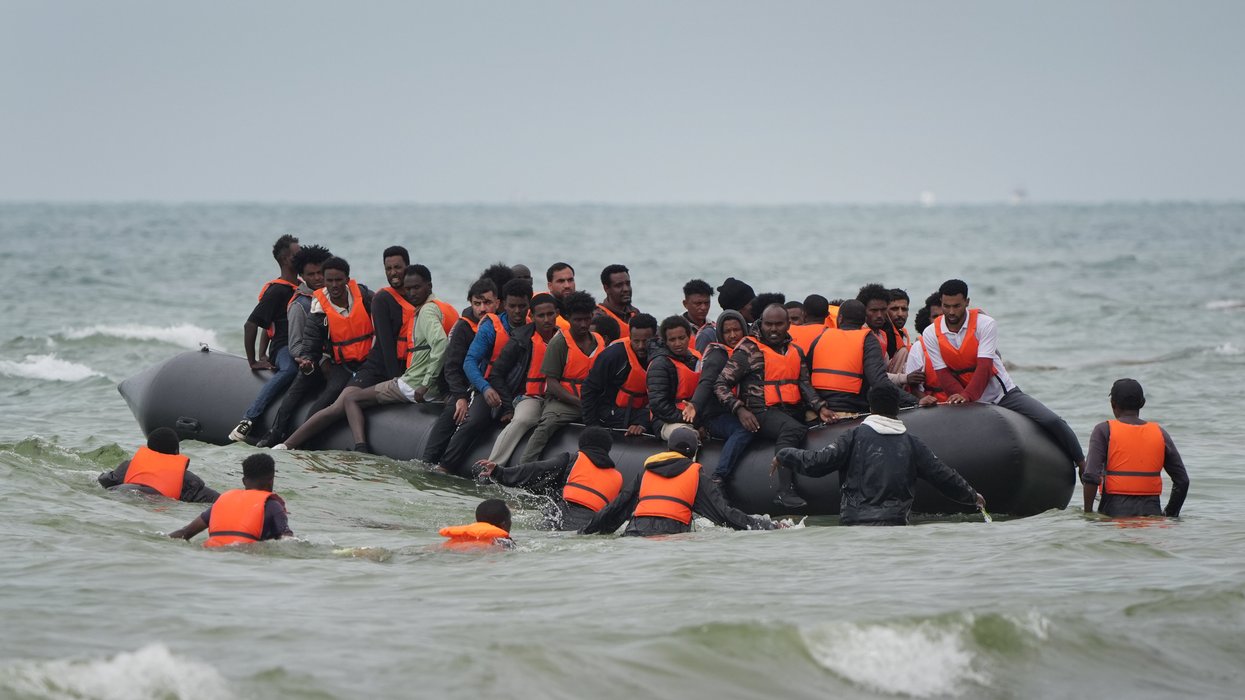 Migrants scramble to board a small boat near Wimereux in France