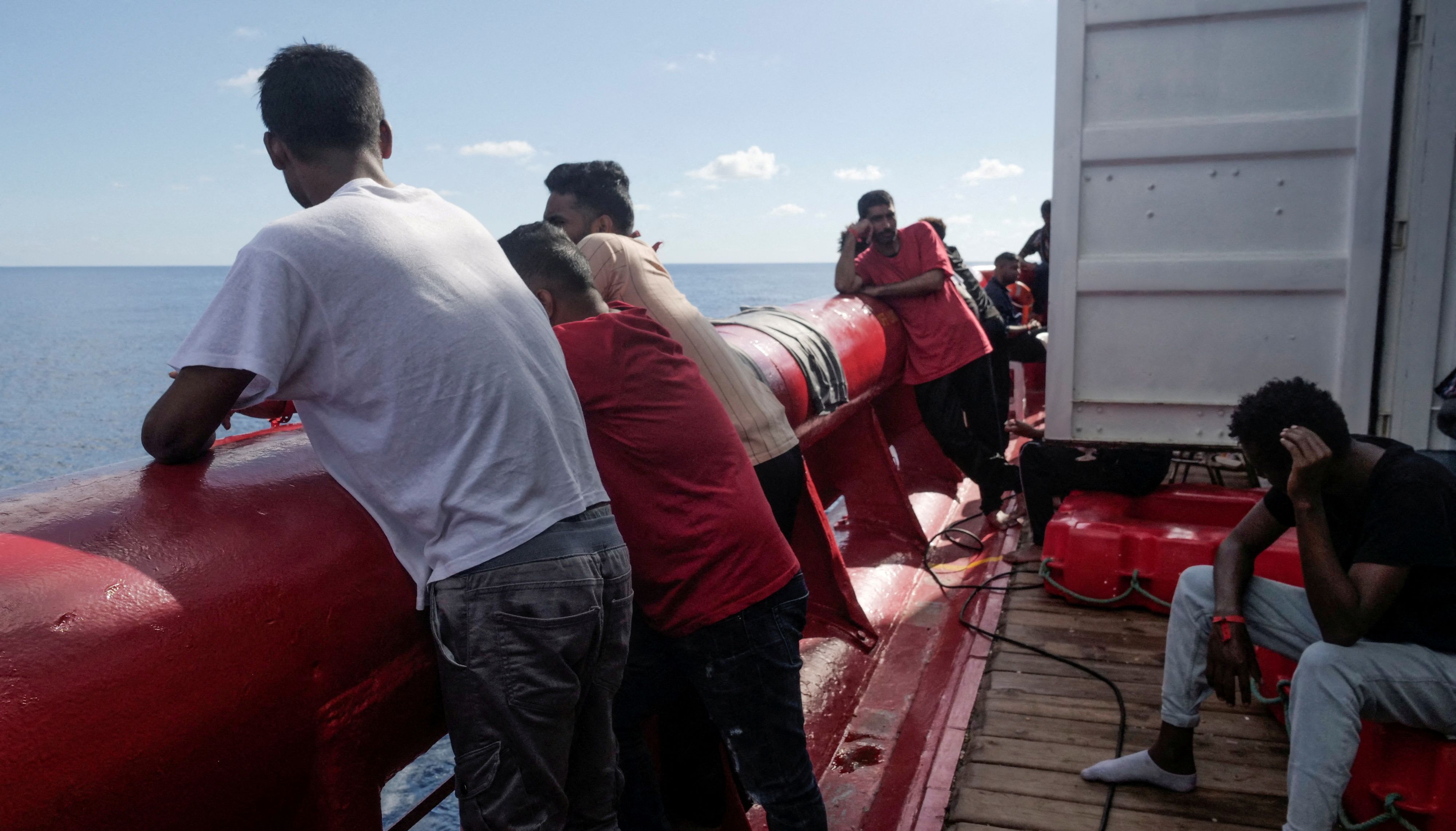 Migrants stand on deck of NGO rescue ship 'Ocean Viking', in the Mediterranean Sea, November 8, 2022. Camille Martin Juan/Sos Mediterranee/Handout via REUTERS ATTENTION EDITORS THIS IMAGE HAS BEEN SUPPLIED BY A THIRD PARTY. NO RESALES. NO ARCHIVES