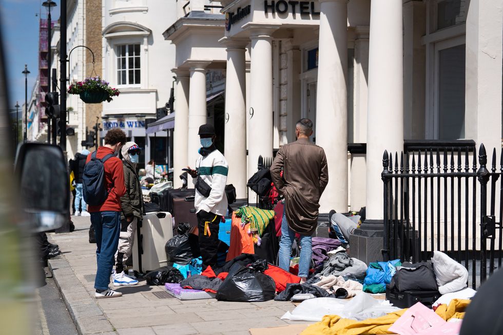 Migrants stood outside a hotel