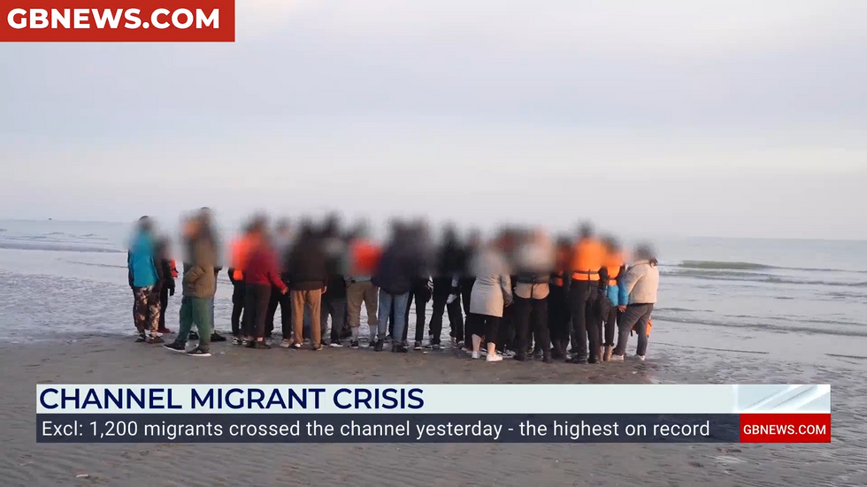 Migrants wait beside the Channel before making the perilous crossing